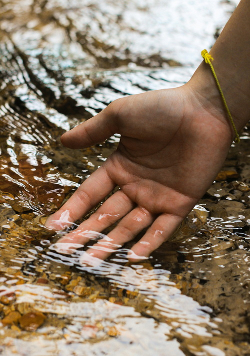 Hands in a stream
